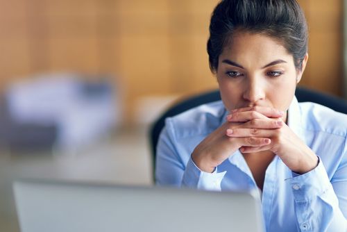 Shot of a young businesswoman looking stressed while working on her laptop - Divorce business owner concept