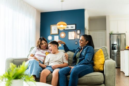 Lesbian family with adopted son talking at home