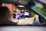 Divorced parents doing child drop off to father - make divorce easier on your child concept